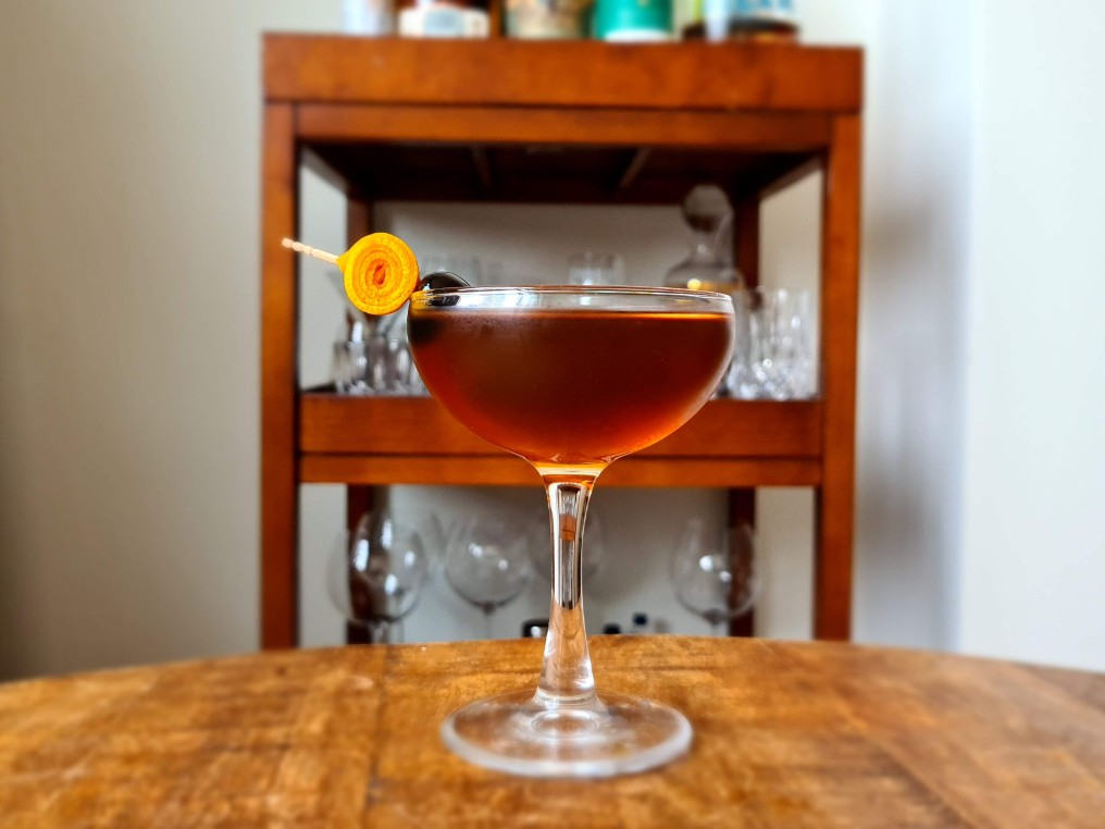 Orange Manhattan Cocktail In Coupe Glass